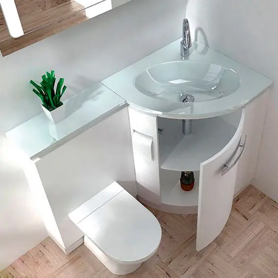 19 a sink with a storage space and counter and a toilet in one unit