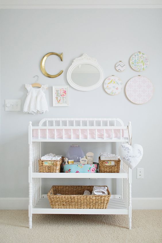 simple white changing table with cubbies for storage