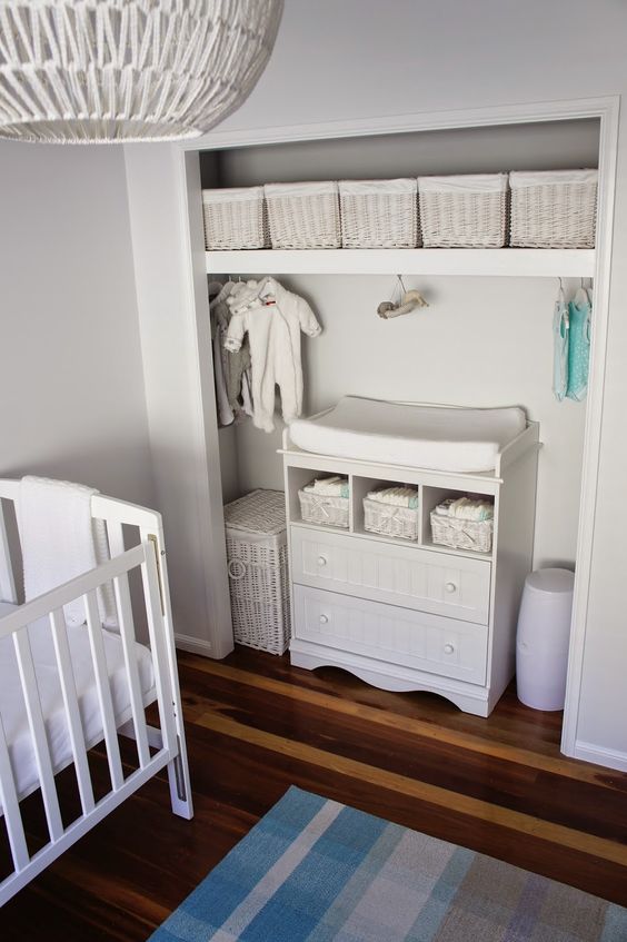 All white closet changing table and cubbies for storage