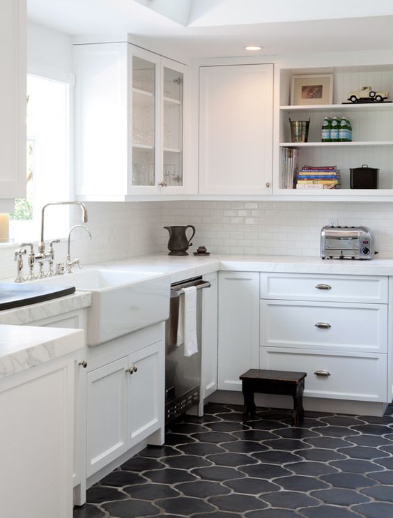 Black Moroccan style tiles for a mid century modern kitchen with white cabinets