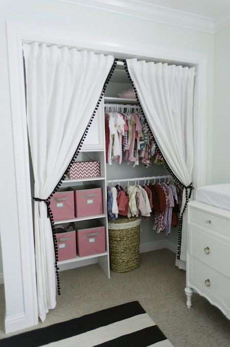 girl's nursery closet with pompom trim curtains