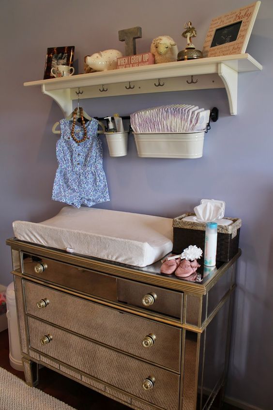 mirror changing table with a rack over it