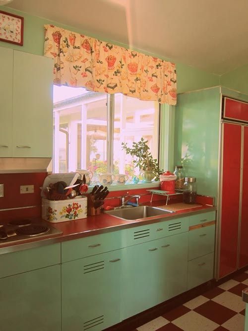 Retro mint kitchen with red countertops and appliances