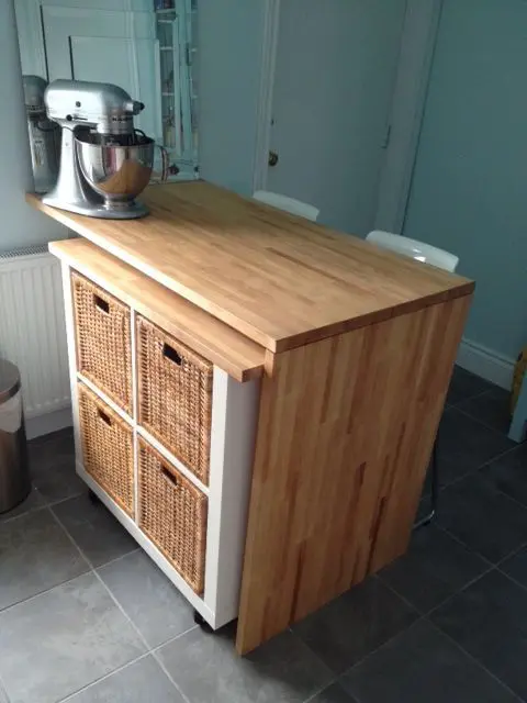 a small kitchen island finished off with an IKEA Kallax unit on casters and with cubbies, it's a super practical idea that will also double counter space