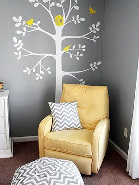 parent nook with a bold yellow chair and an applique on the wall