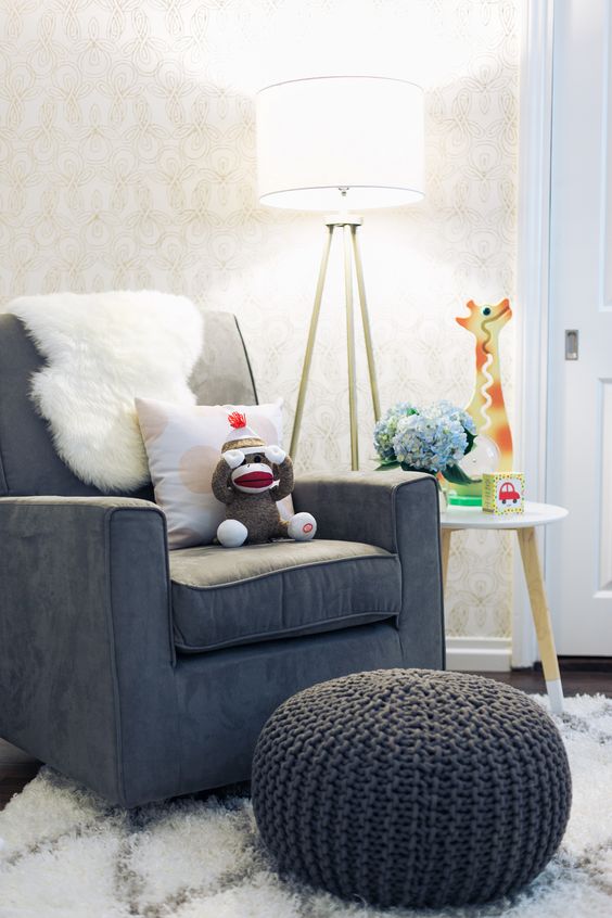 comfy chair with a knitted ottoman and a floor lamp
