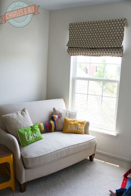 loveseat with pillows in a baby room