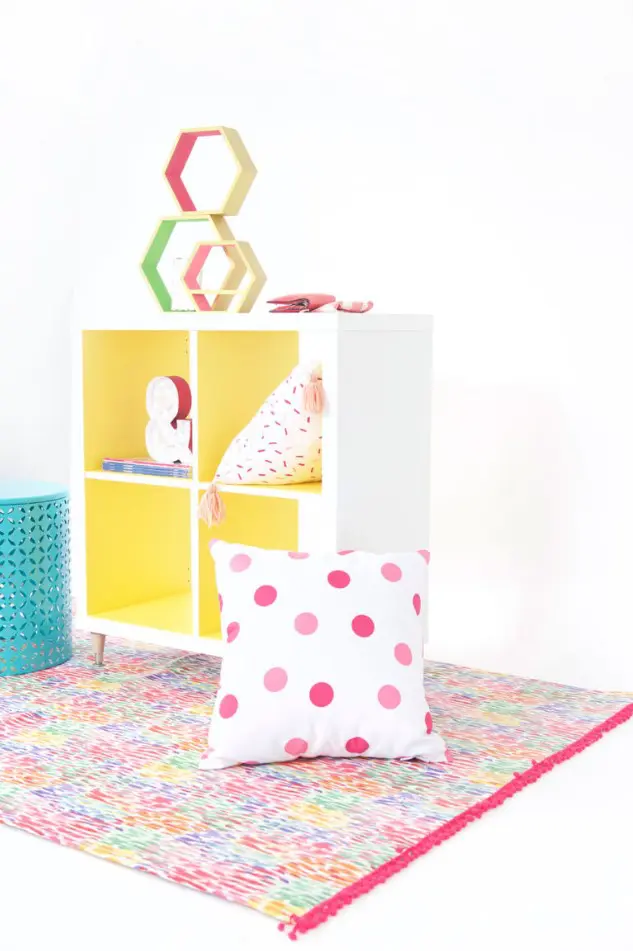 DIY Kallax hack with new legs and bold yellow paint will be a nice idea for a colorful space or a kids' room