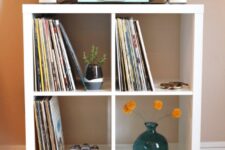 a DIY vinyl record shelf from Kallax, with stained legs and some decor is a lovely idea of a small media console
