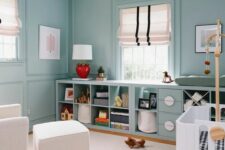 a beautiful pastel blue room with matching IKEA Kallax units finished with doors and baskets is amazing