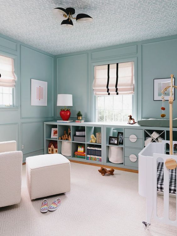 a beautiful pastel blue room with matching IKEA Kallax units finished with doors and baskets is amazing