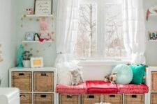 a bright kids’ room with a storage bench by the window built of several IKEA Kallax units, with bright decor