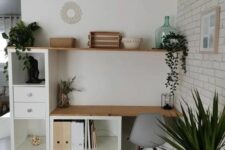 a cool working space with a couple of Kallax units forming a desk and a storage piece, an open shelf and potted greenery