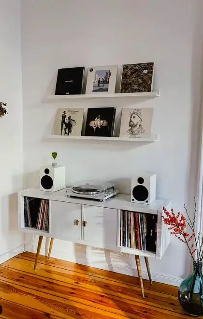 a small and cool media console of an IKEA Kallax unit on tall legs and with vinyl inside is a bold hack to try