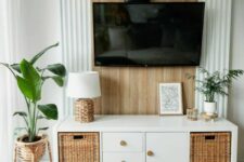 a stylish IKEA Kallax TV console with woven drawers and doors with knobs is a cool solution for a Scandinavian space