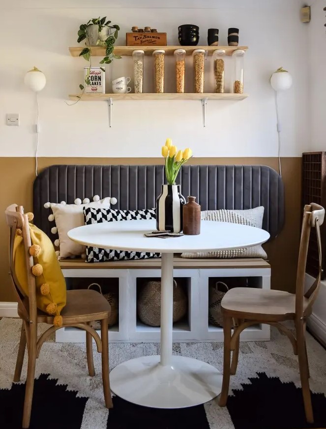a stylish breakfast nook with a Kallax bench with woven bags and a soft back, chairs and a round table