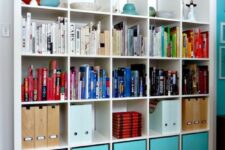 an IKEA Expedit piece with turquoise cubbies, folders, colorful books and some decor is a lovely solution