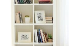 an IKEA Kallax unit turned into a bookshelf, with stained legs and pretty decor is a lovely idea