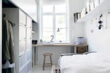 an airy Scandinavian bedroom with a windowsill desk and a stool, a wardrobe, a low bed and a shelf with cubbies