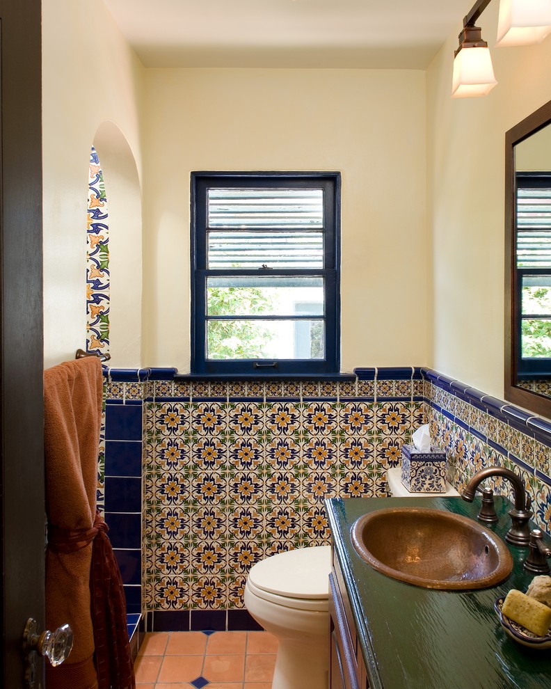 blue trim tiles separates spanish tiles from the painted parts of bathroom's walls (Avente Tile)