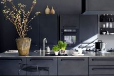cozy industrial all-black kitchen clad with metal