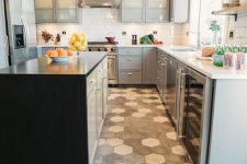 grey and white hex tiles in the cooking zone contrast the dark laminate