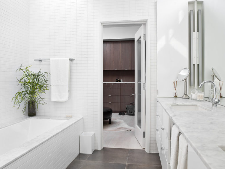 a pure white bathroom with dark gray flooring (Searl Lamaster Howe Architects)
