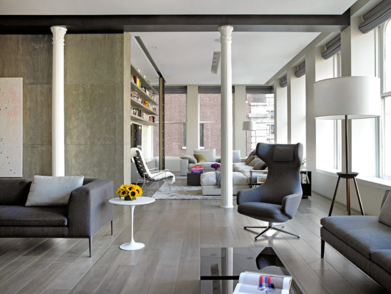 gray hardwood flooring is perfect for an open space with concrete walls (Axis Mundi)