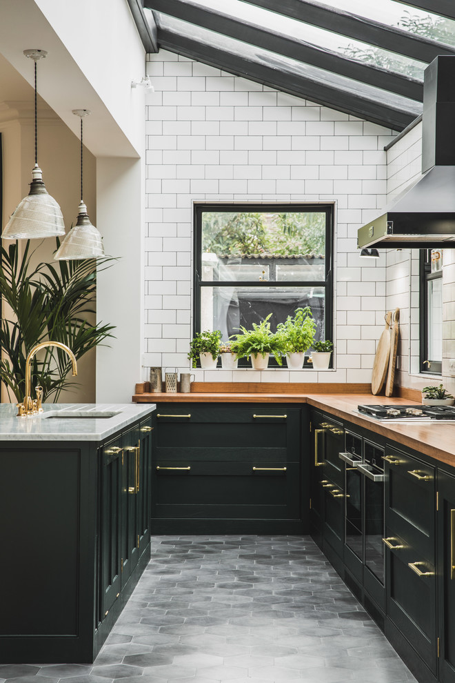 whitewash-inspired hexagonal tiles on a traditional kitchen with black cabinets (Lukonic)