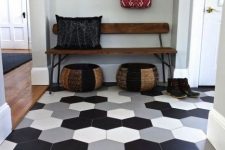 large scale hexagon tiles in different colors in the entryway flow into warm-colored laminate in the rest of the space