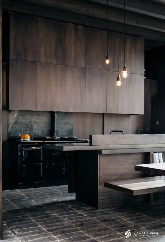 moody industrial style kitchen with timber cabinets and a black freestanding cooker