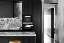 moody monochrome kitchen with veined marble surfaces