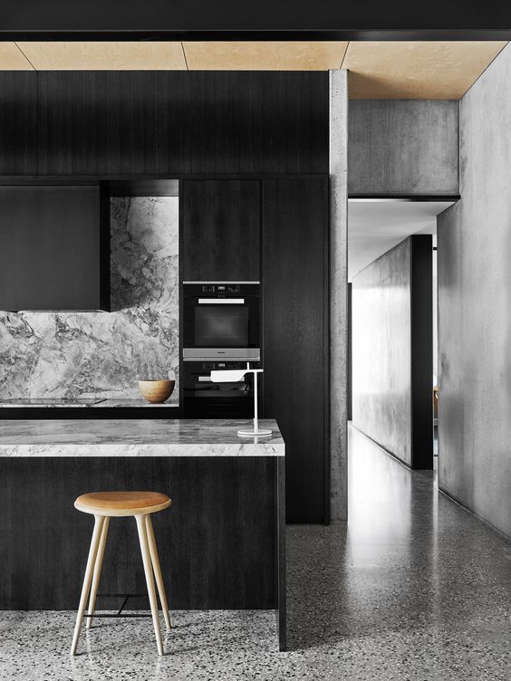 moody monochrome kitchen with veined marble surfaces
