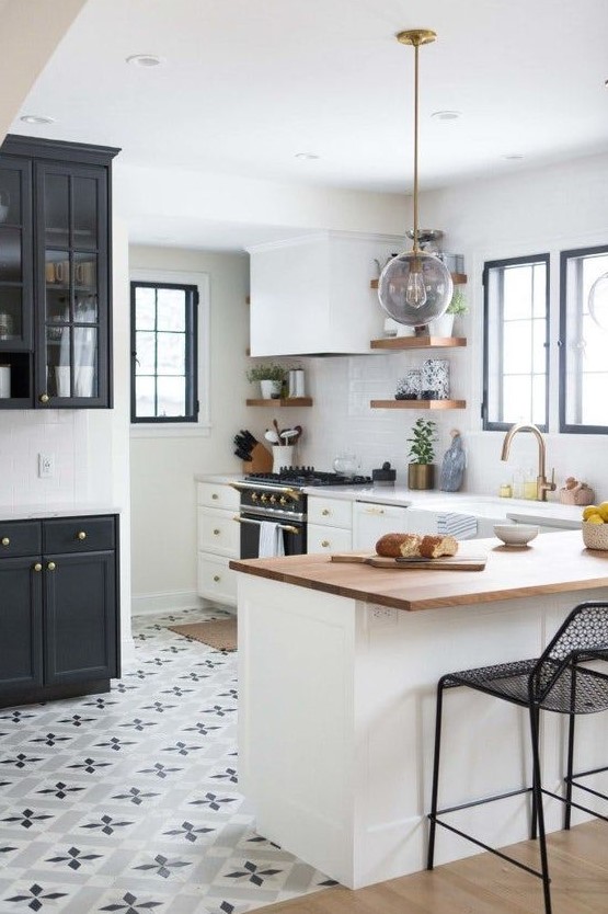 Printed mosaic tiles in the kitchen and light colored laminate with a sharp transition