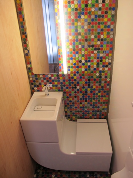 A combo unit plus an accent wall made of recycled bottle caps is definitely a good looking solution for a tiny space.