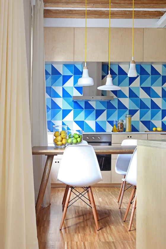Blue tiles in several colors comprise a cool kitchen backsplash