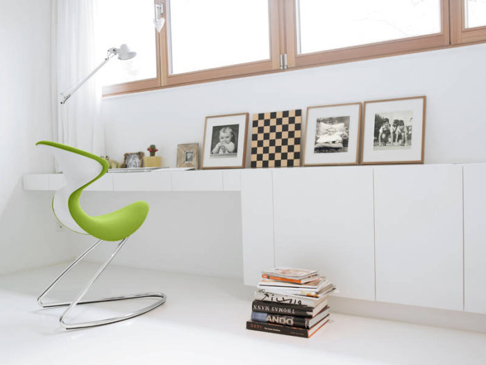 This white study nook by the window is enlivened with the help of just one lime green Oyo chair