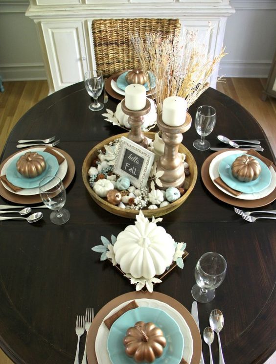brown tablescape with blue accents, candles in antique candle holders and wheat