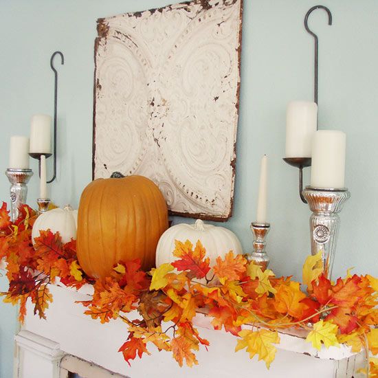 faux leaf garland, pumpkins and candles on vintage candle holders
