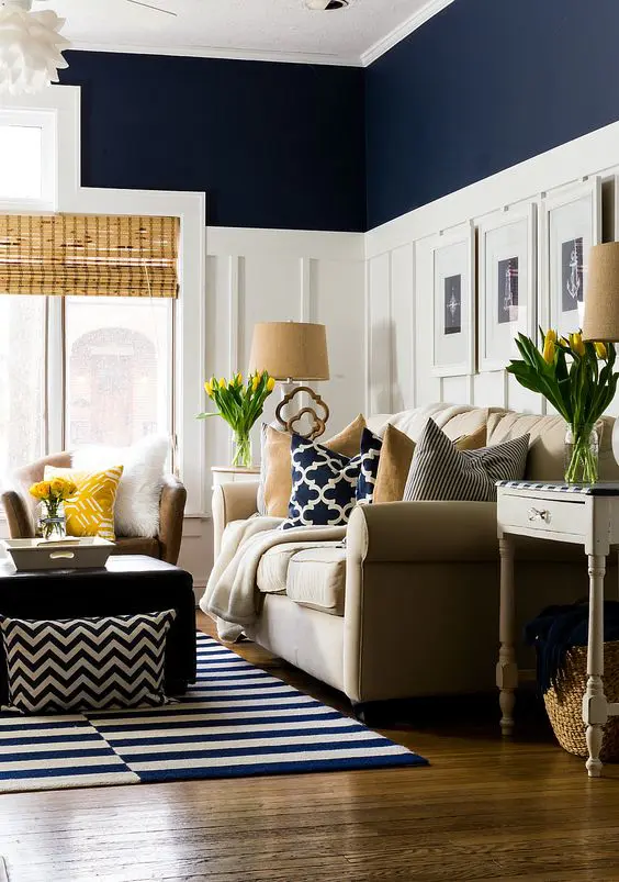 navy living room with tall white wainscoting