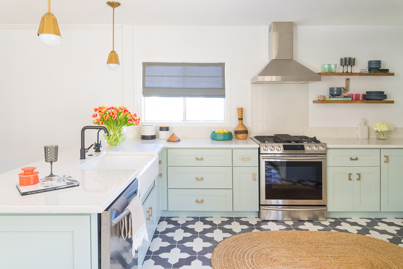 The color of the cabinets is mint, there are cute brass touches and mosaic tile floors