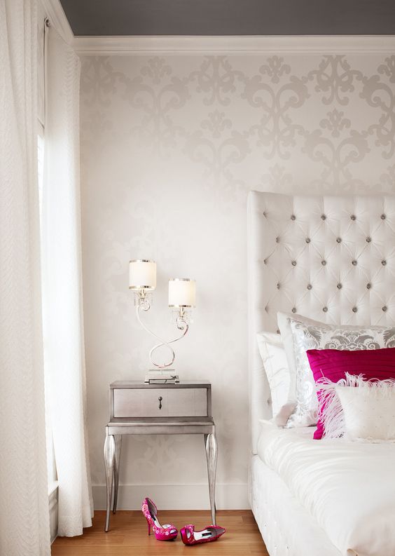 delicate patterned wallpaper adds dimension to this bedroom