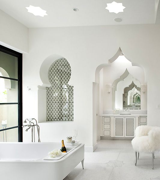 Moroccan style bathroom with an arch reflected in the mirror for creating an effect