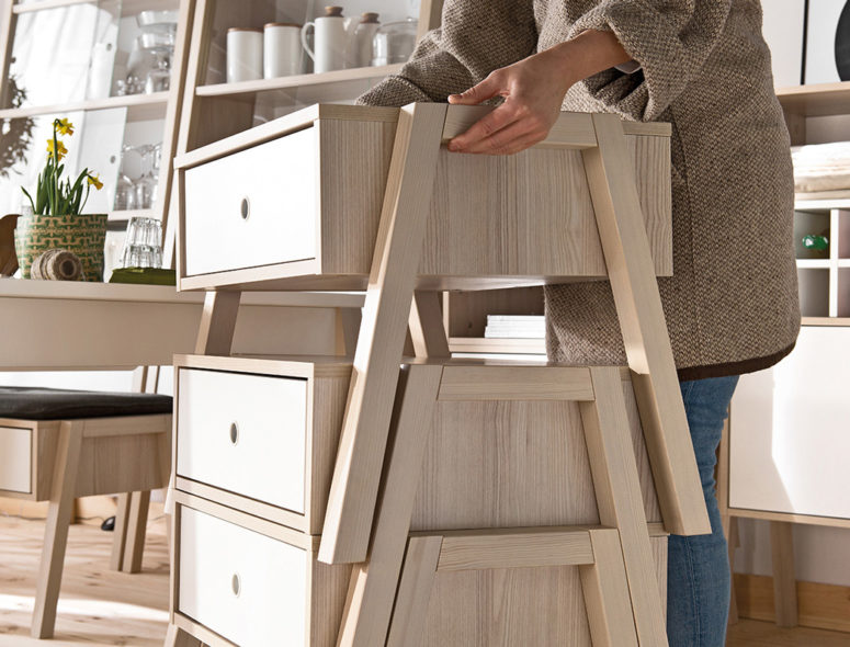 The furniture is modular, stackable and is made of blond wood
