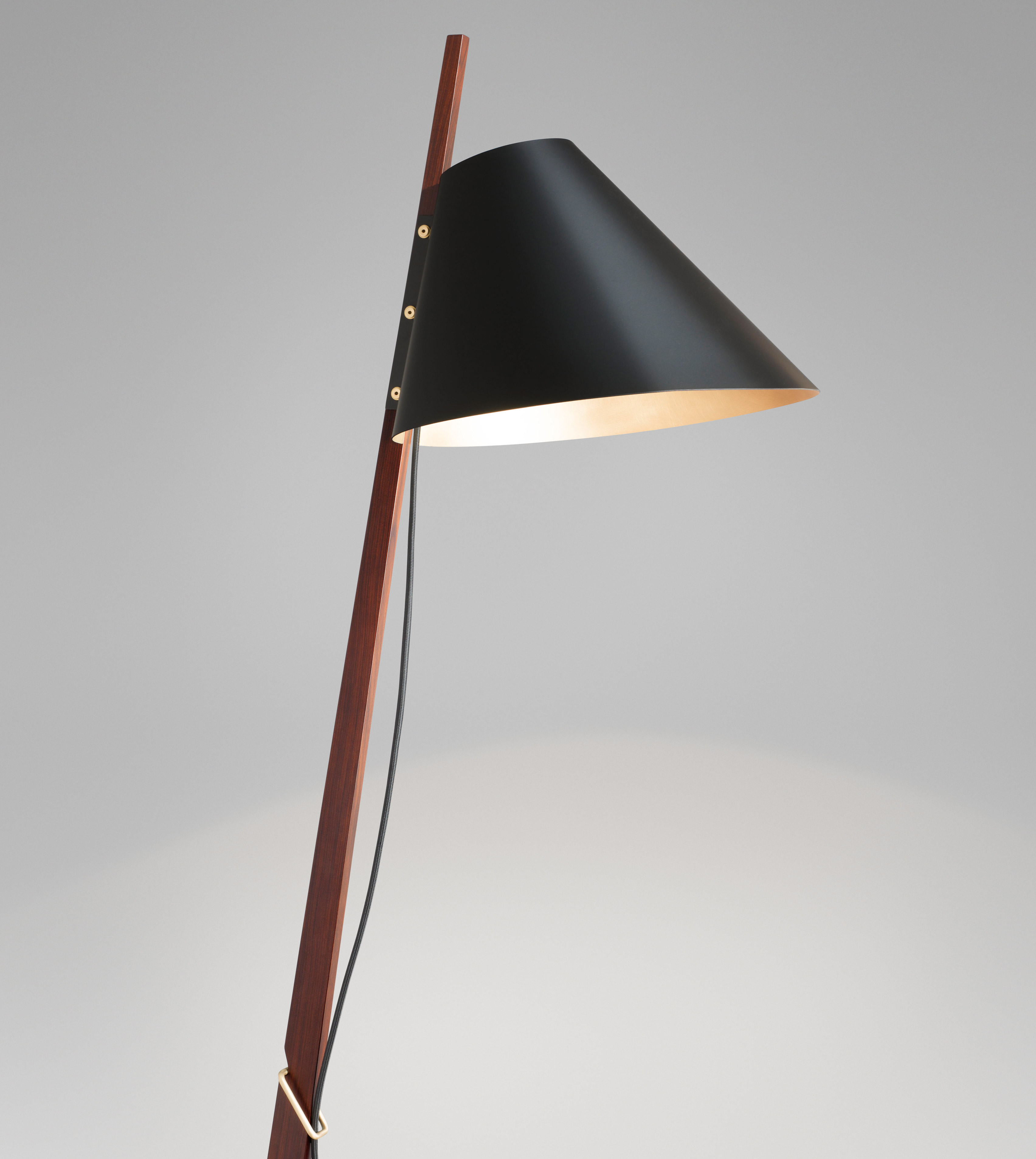 The lampshade features a duotone finish, matte black exterior with satin brass interior, creating an ambient feel