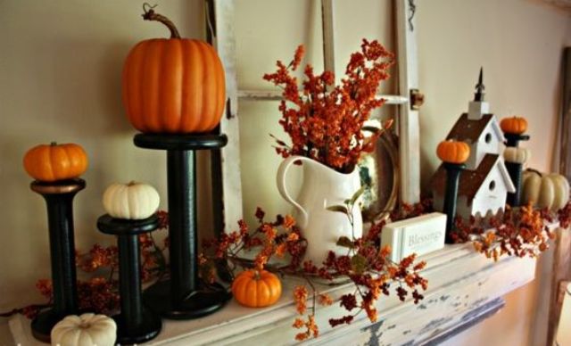 pumpkins on stands, faux leaves and a vintage window frame