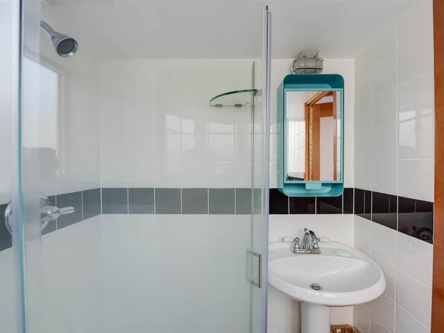 The bathroom has everything necessary, and here turquoise accents help to accentuate the space