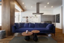 05 The rich blue sofa grounds the open living space