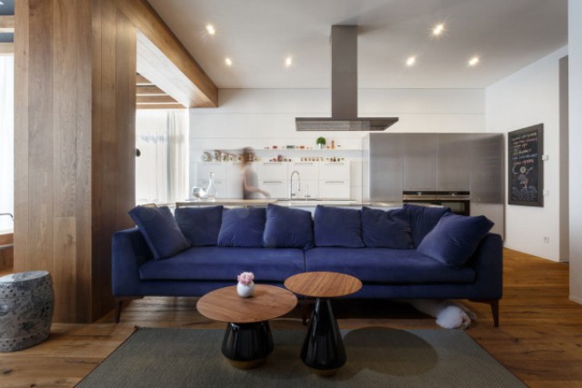 The rich blue sofa grounds the open living space