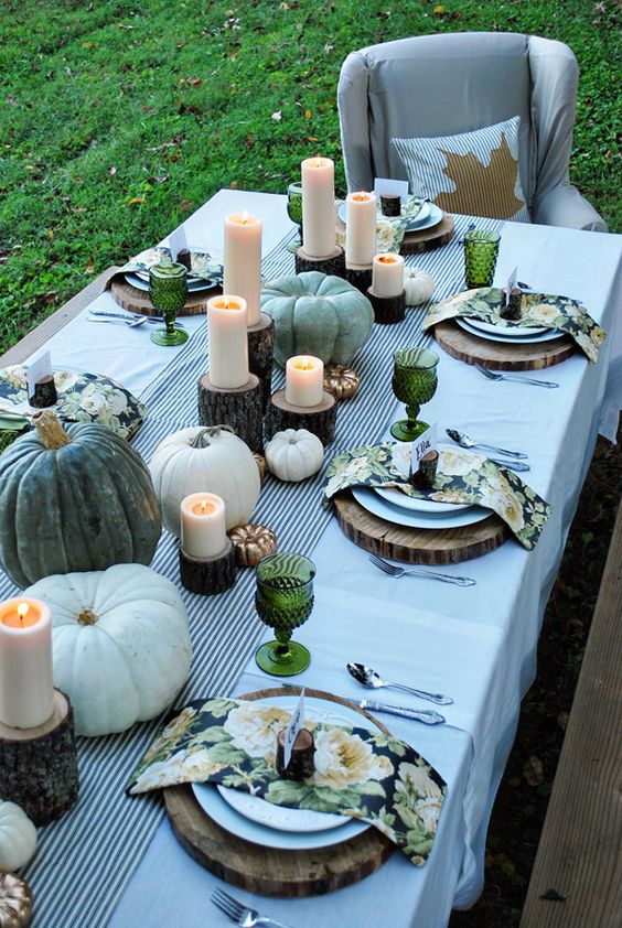 green and white pumpkins, candles on wood stumps, floral napkins